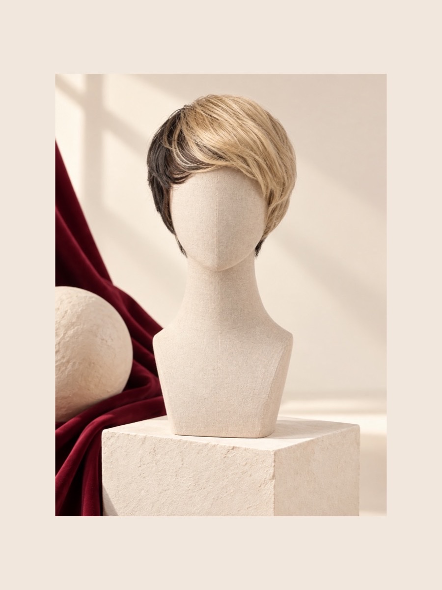 Short blonde fashion wig displayed on a faceless linen mannequin