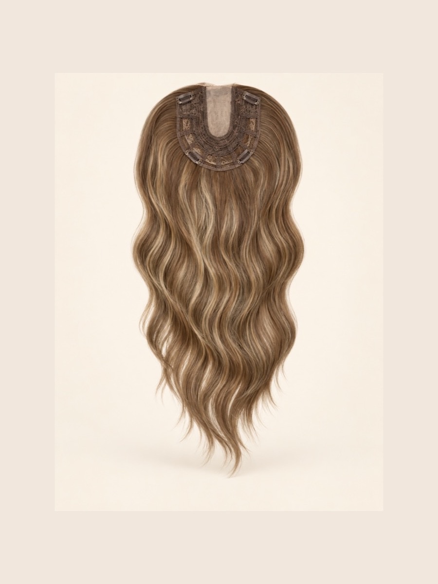 Long highlighted wavy topper showing its lace base on a warm cream background