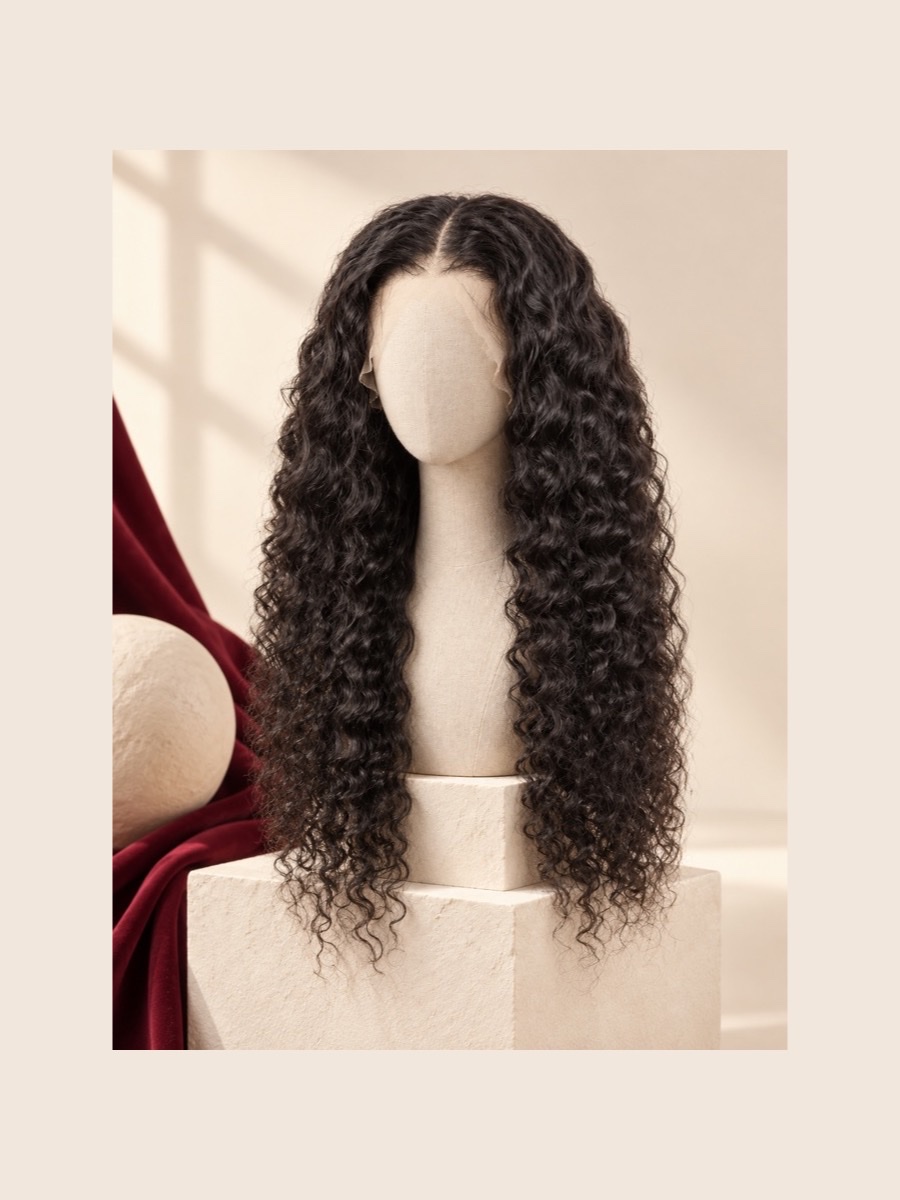 Long black deep-wave wig displayed on a faceless linen mannequin