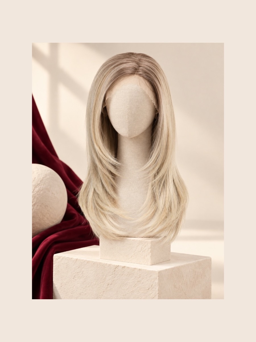 Long highlighted blonde monofilament wig displayed on a faceless linen mannequin